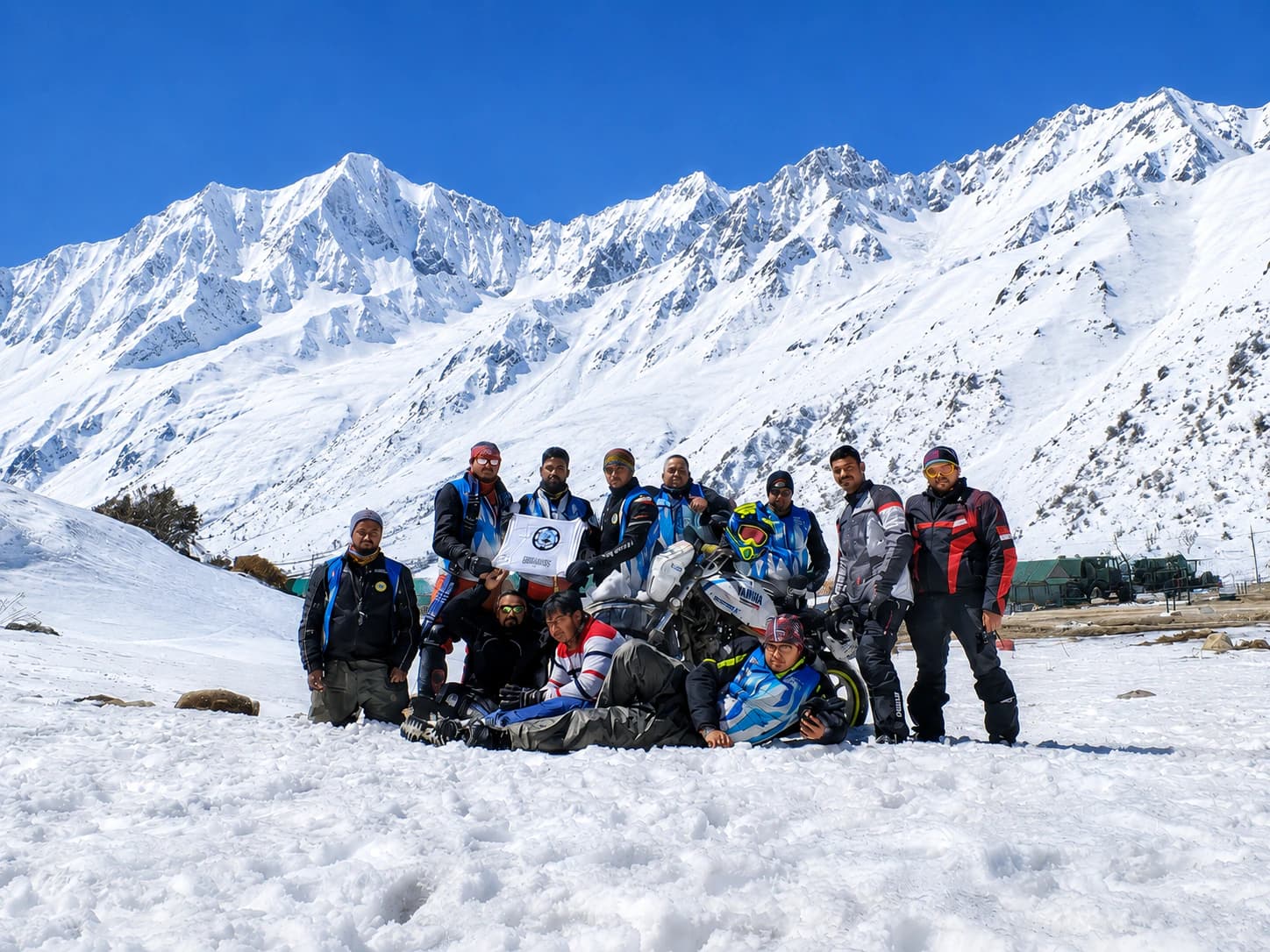 Motology Adventures riders gathered with their motorcycles in the snow-covered Himalayas