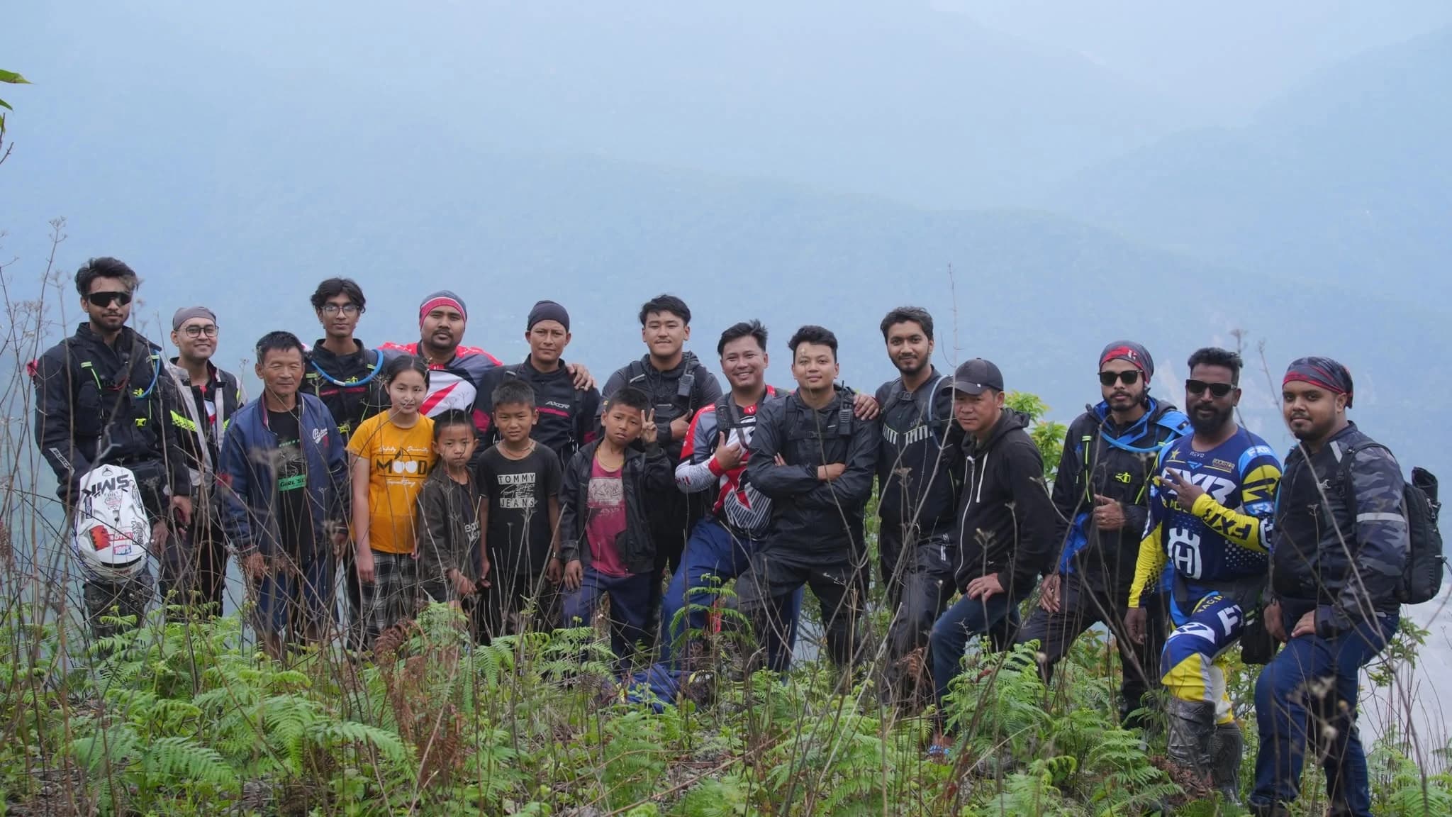 Motology riders and local families gathered together on a misty hillside